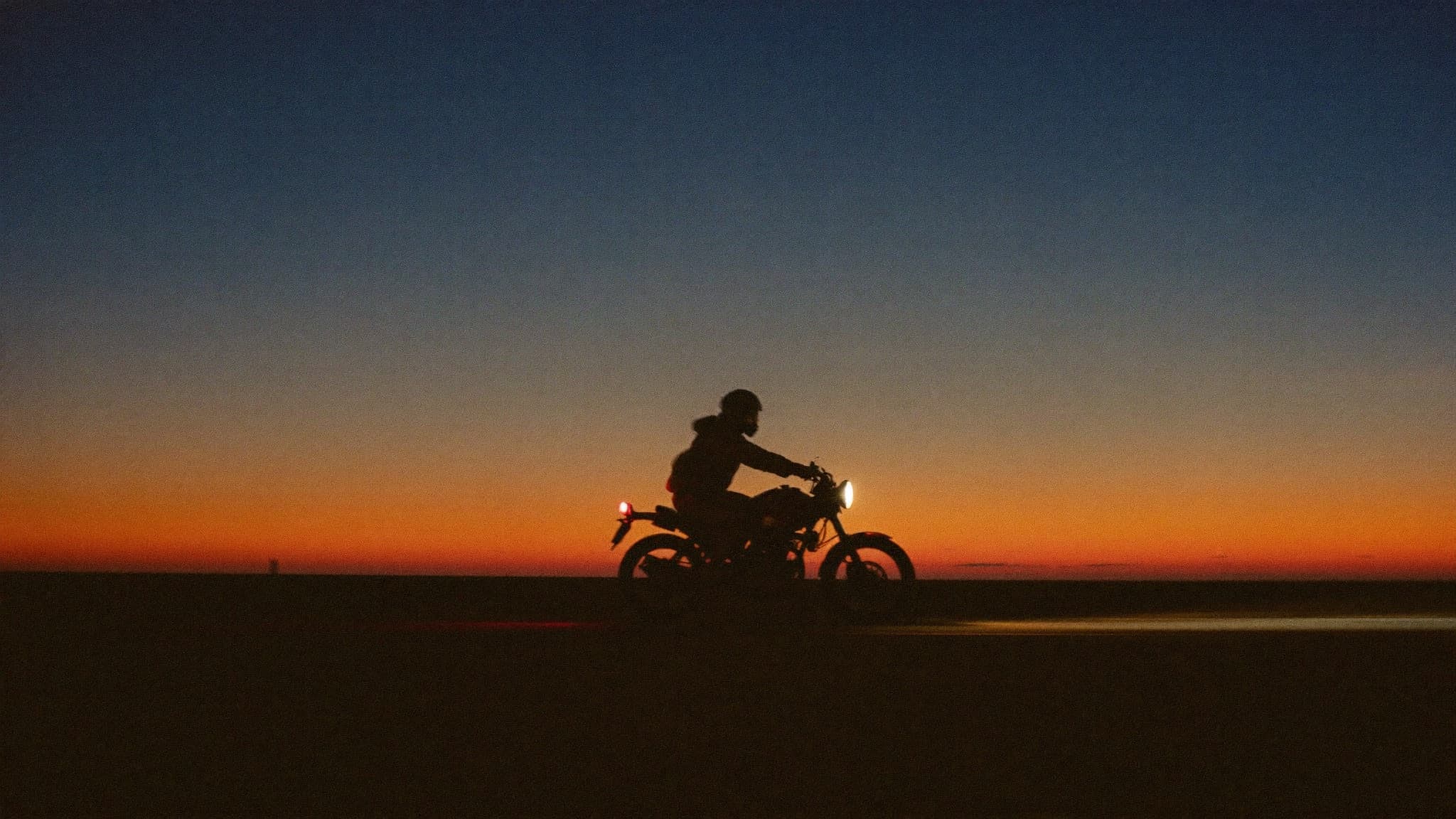 Rider on an open highway at dusk